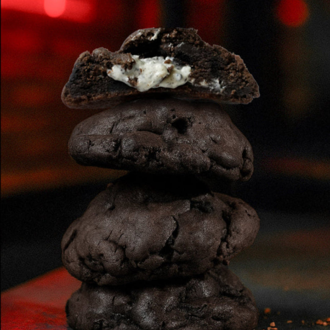 Stack of chocolate cookies with a blurred red light in the background