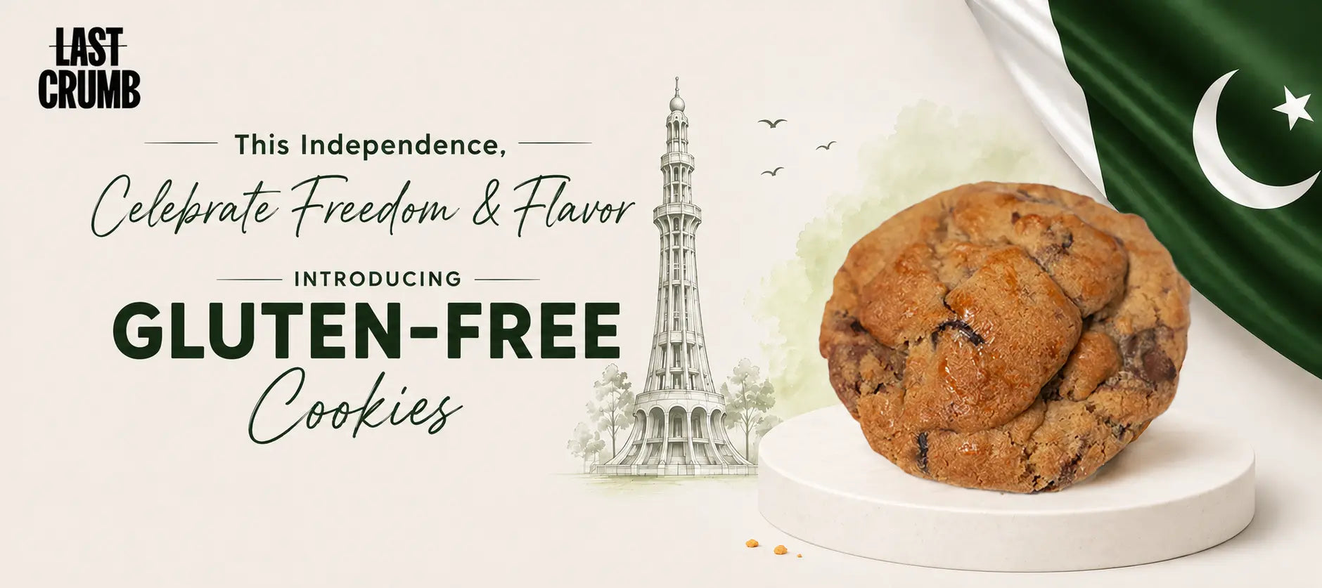 A promotional graphic for Last Crumb Gluten-Free Cookies, featuring a large chocolate chip cookie on a white pedestal next to a green Pakistani flag, with a sketch of the Paktiwar Tower and text celebrating independence.