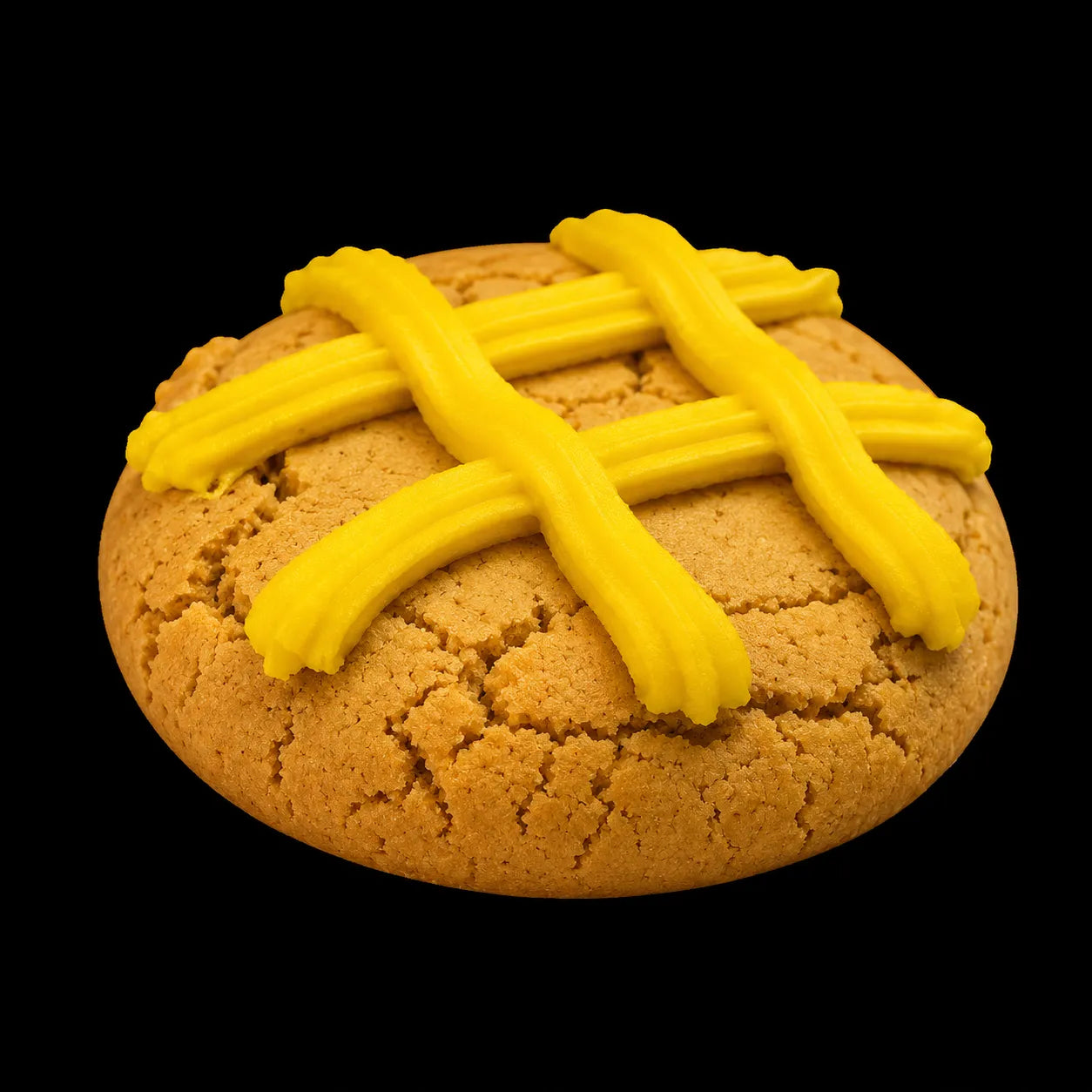 A round lemon cookie topped with bright yellow lattice-style icing, isolated on a solid black background.