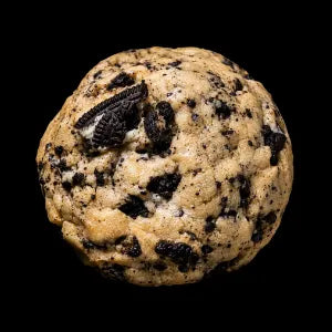 A single Oreo cookie with visible cookie oreo pieces, photographed against a solid black background.